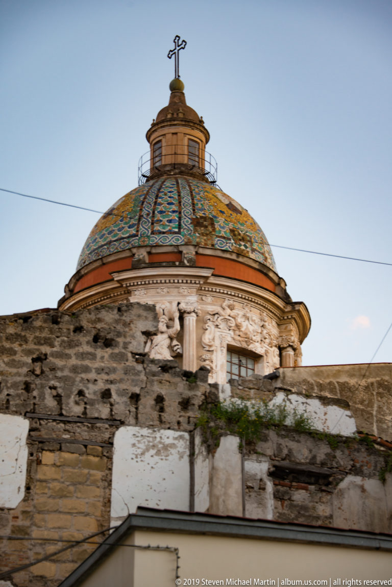The green-and-gold tiled dome and lantern of Santa Caterina rise above the surrounding rooftops.