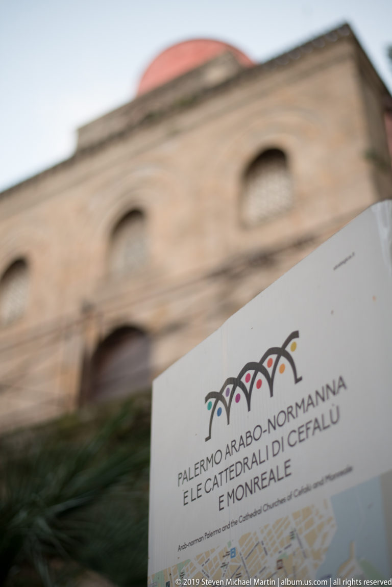A stone plaque names the Arab-Norman Palermo and the cathedrals of Cefalù and Monreale.