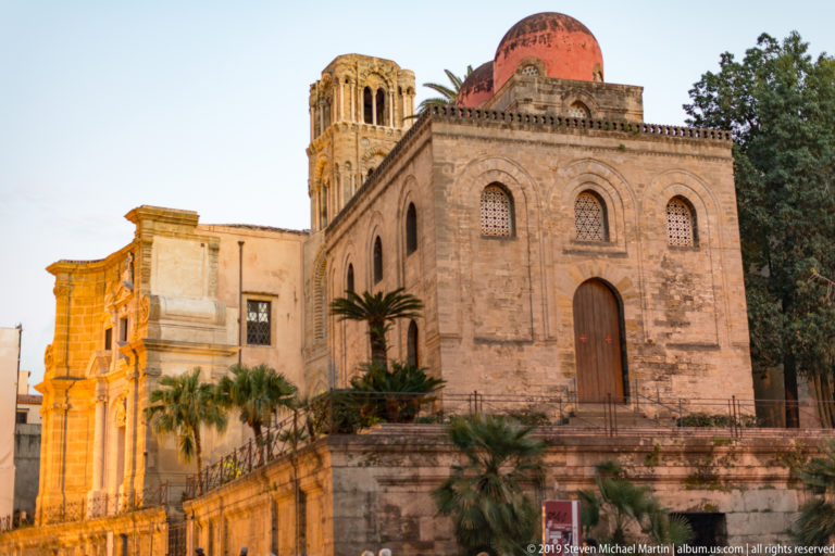 San Cataldo’s arched side wall and red dome sit before the Martorana’s taller bell tower.