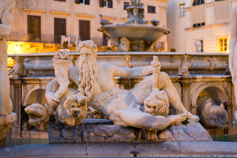 Reclining marble figures and carved heads line the lower basin of Fontana Pretoria.