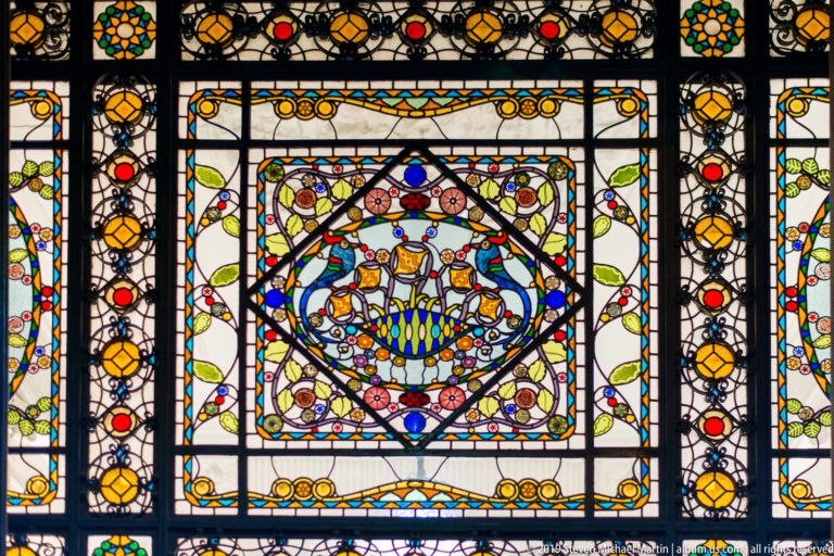 Dense Palermo rooftops and scattered lights extend toward a dark mountain ridge at night.