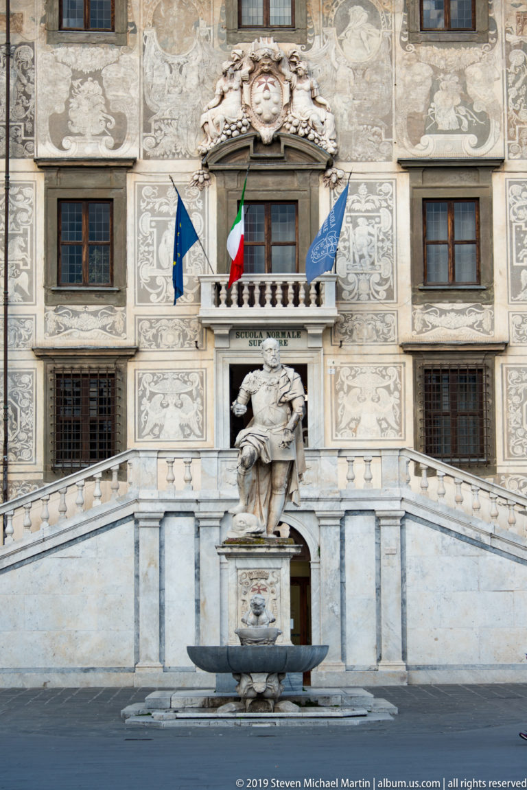Palazzo della Carovana with Vasari’s sgraffito façade, monumental staircase, heraldic sculpture, and rows of windows.