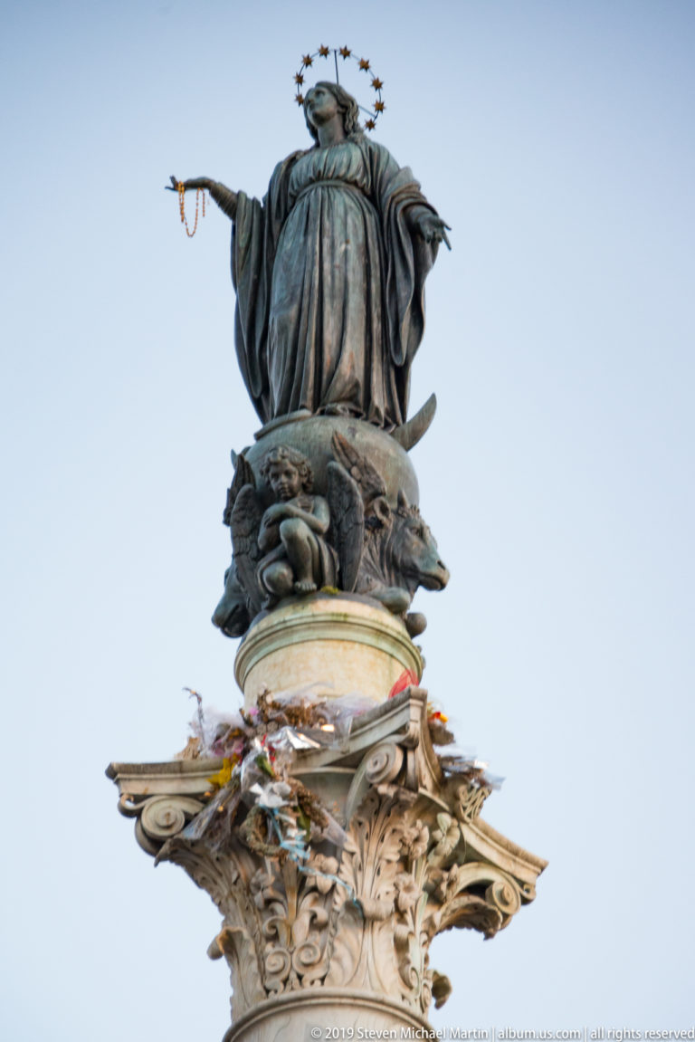 Bronze Virgin Mary with star halo atop the ornate Column of the Immaculate Conception near the Spanish Steps.