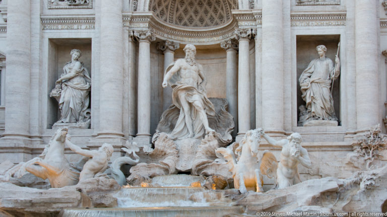 Central Trevi Fountain ensemble with Oceanus, flanking statues, sea horses, carved rockwork, and flowing water.