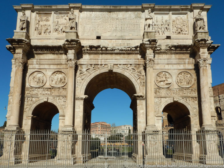 Frontal Arch of Constantine with three openings, columns, roundels, relief panels, captive statues, and inscribed attic.