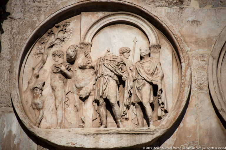 Circular relief with draped figures and a sacrificial animal on the Arch of Constantine.