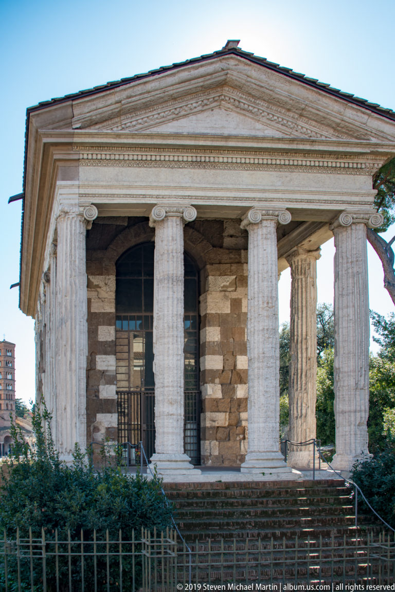 Front and side of the Temple of Portunus with fluted Ionic columns, triangular pediment, and high podium.