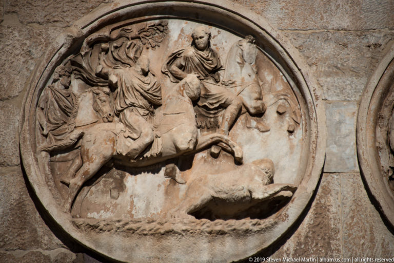 Circular relief with mounted hunters and an animal in an energetic hunting scene on the Arch of Constantine.