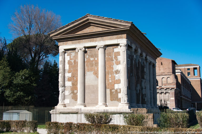 Rectangular ancient Roman temple with Ionic columns, high podium, deep portico, and pediment at the Forum Boarium.