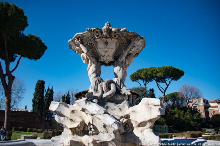 Heraldic basin and paired Tritons supporting the shell of the Fontana dei Tritoni near the Forum Boarium.