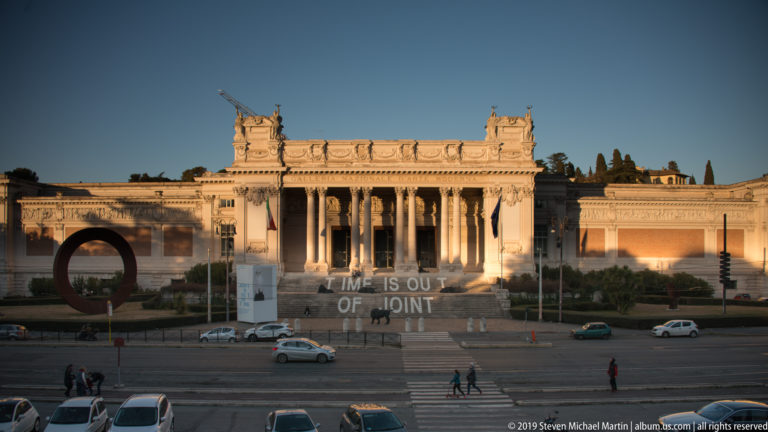 Grand columned façade and broad steps of Rome’s National Gallery of Modern and Contemporary Art with contemporary installations outside.
