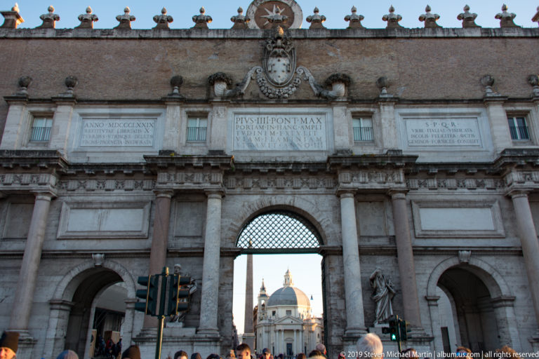 Inner façade of Porta del Popolo with Bernini’s Chigi heraldry and 1655 inscription facing Piazza del Popolo.
