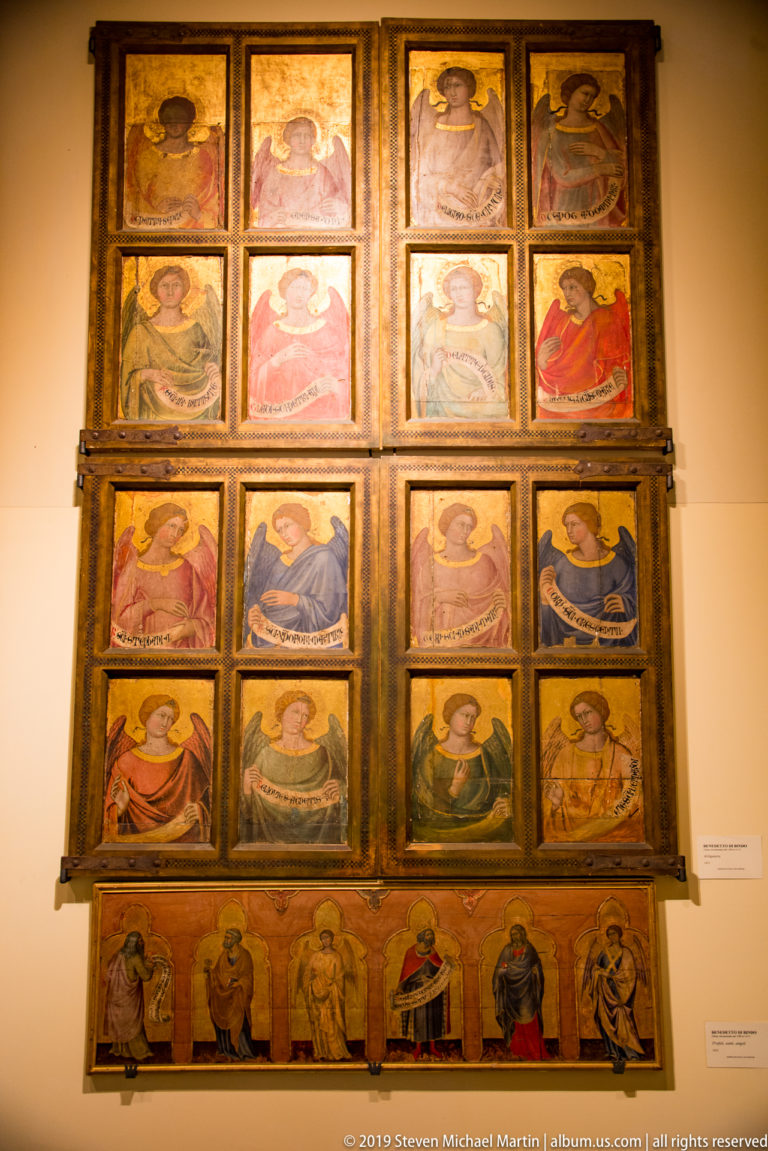 Large framed polyptych with multiple rows of painted haloed saints and smaller narrative scenes arranged in separate compartments.