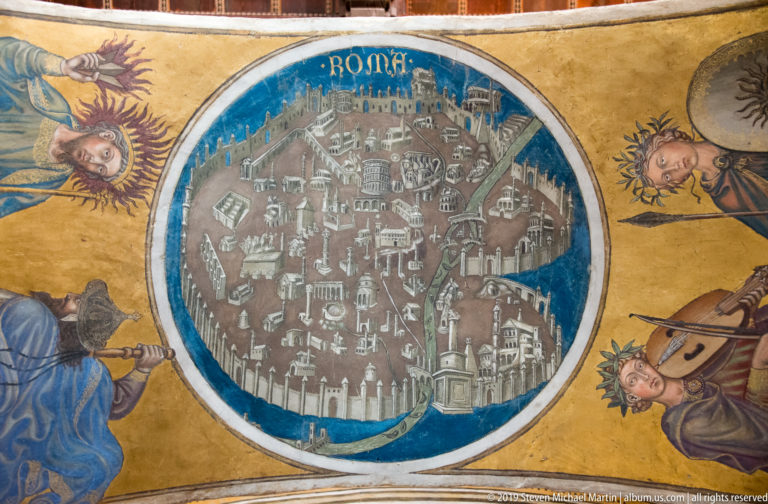 Painted circular bird's-eye view of a walled medieval city surrounded by a blue border and figures on a gold field.