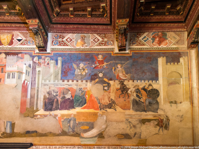 Fragmentary Ambrogio Lorenzetti fresco with architecture, groups of figures, and scenes of violence from the Bad Government section.