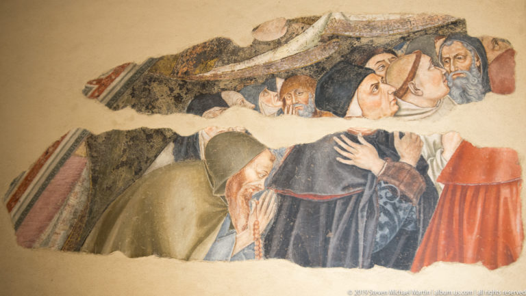 Fragmentary fresco with a veiled woman embracing another figure while older men look on through areas of missing plaster.