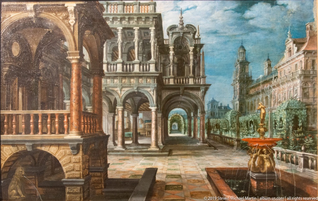 Painted palace courtyard with arcades, columns, balustraded garden terrace, and gilded fountain under a blue sky.