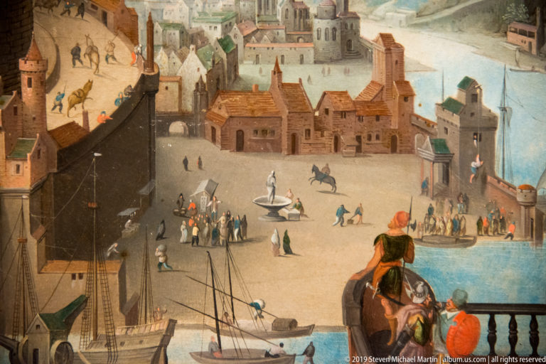 Painted waterfront square with fountain, crowds, horses, sailing boats, fortified buildings, and steep streets.