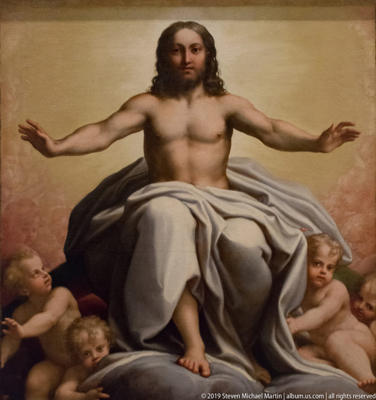 Seated Christ with bare torso and outstretched arms, draped in pale cloth and surrounded by small cherubs.