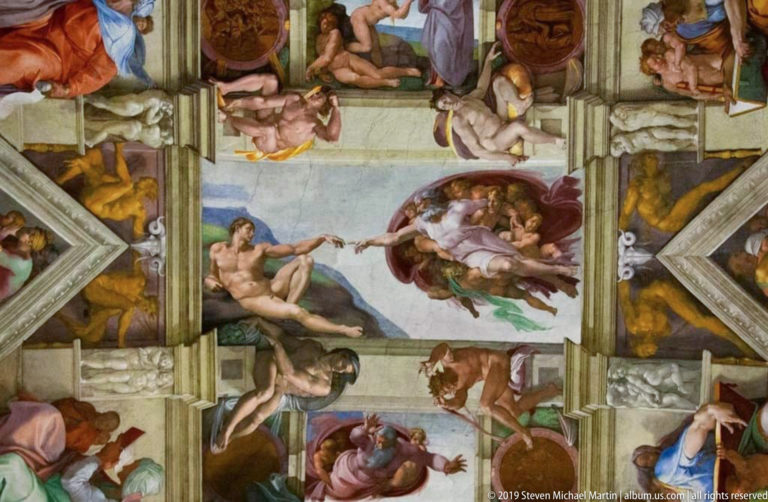 Michelangelo's Creation of Adam centered on the Sistine Chapel ceiling, surrounded by painted figures and architectural framework.
