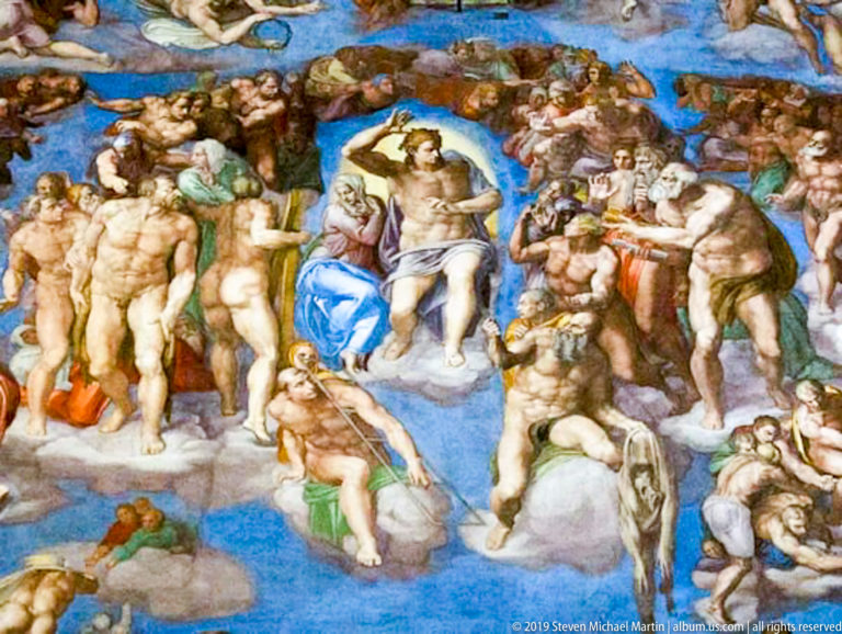 Detail of Michelangelo's Last Judgment showing Christ surrounded by densely grouped figures against a blue background.