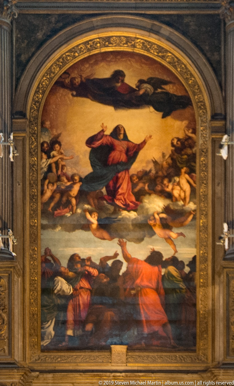 Large arched altarpiece showing the Virgin rising among angels above gesturing figures, framed by gilded architectural molding.