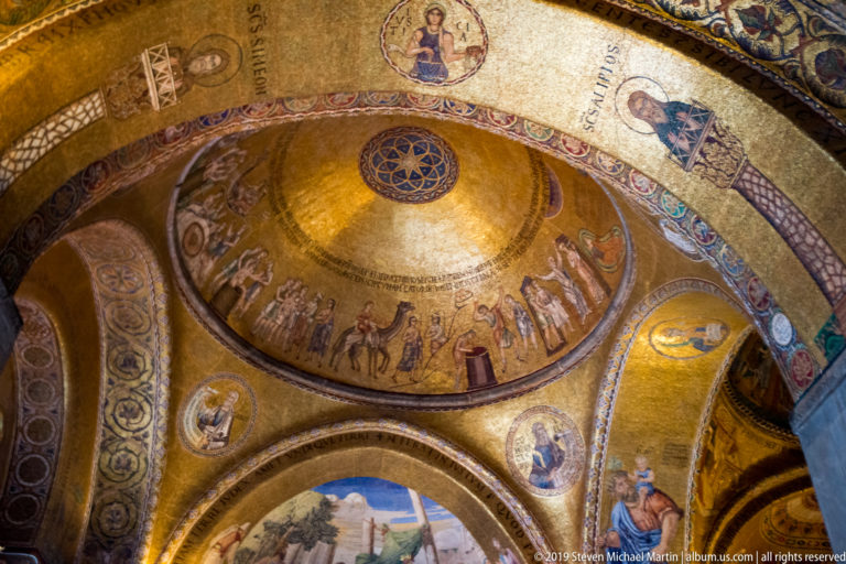 Gold mosaic dome with ring of figures, adjoining arches, saint medallions, and narrative scenes inside St. Mark’s Basilica.