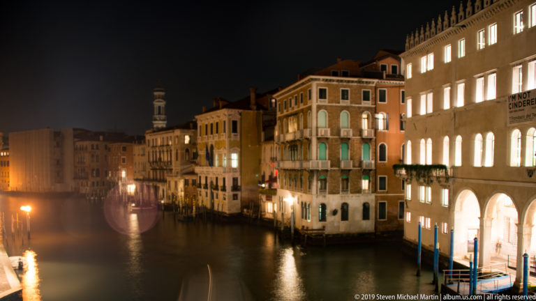 Palazzi lining the Grand Canal at night under nighttime illumination in Venice.