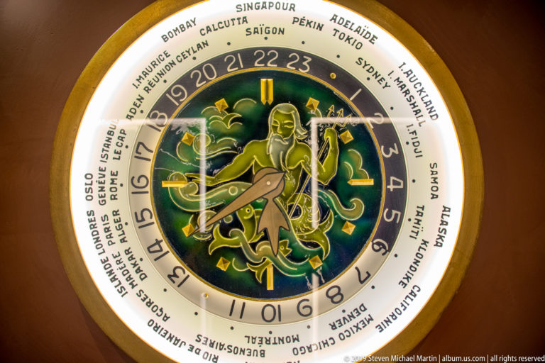 Decorative world-time clock with zodiac motif under nighttime illumination in Venice.
