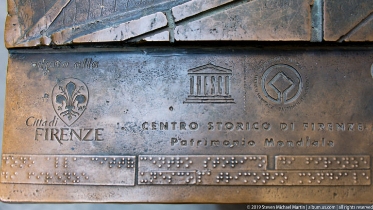 Bronze plaque for the Historic Centre of Florence World Heritage site with city and UNESCO emblems and raised Braille text.