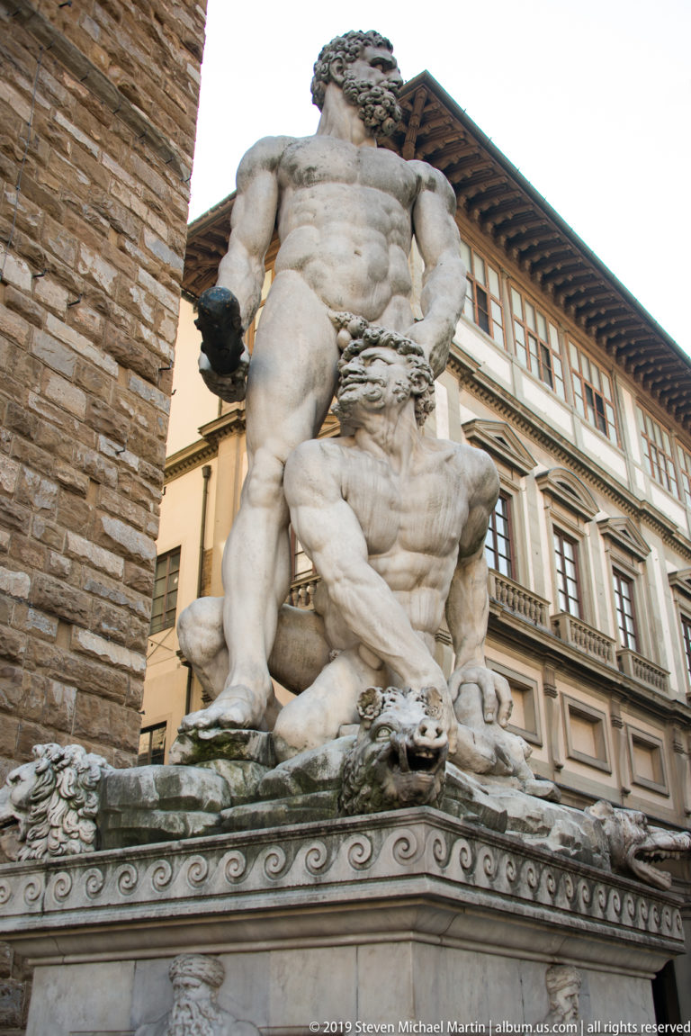 Marble Hercules wrestling the centaur Nessus in a twisting two-figure group near the Loggia dei Lanzi.