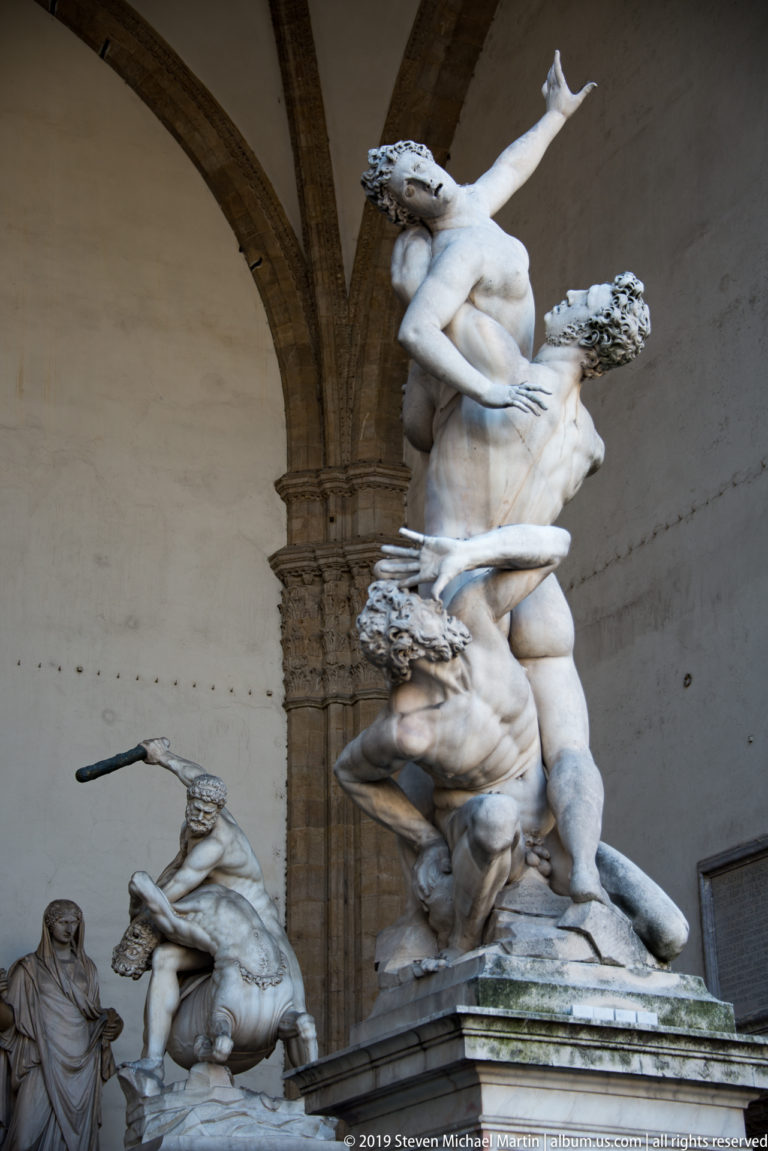Giambologna’s three-figure marble Rape of the Sabine Women twisting upward beneath an arch of the Loggia dei Lanzi.