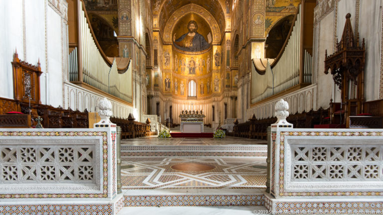 The patterned nave leads toward the sanctuary and monumental Christ mosaic in the apse.