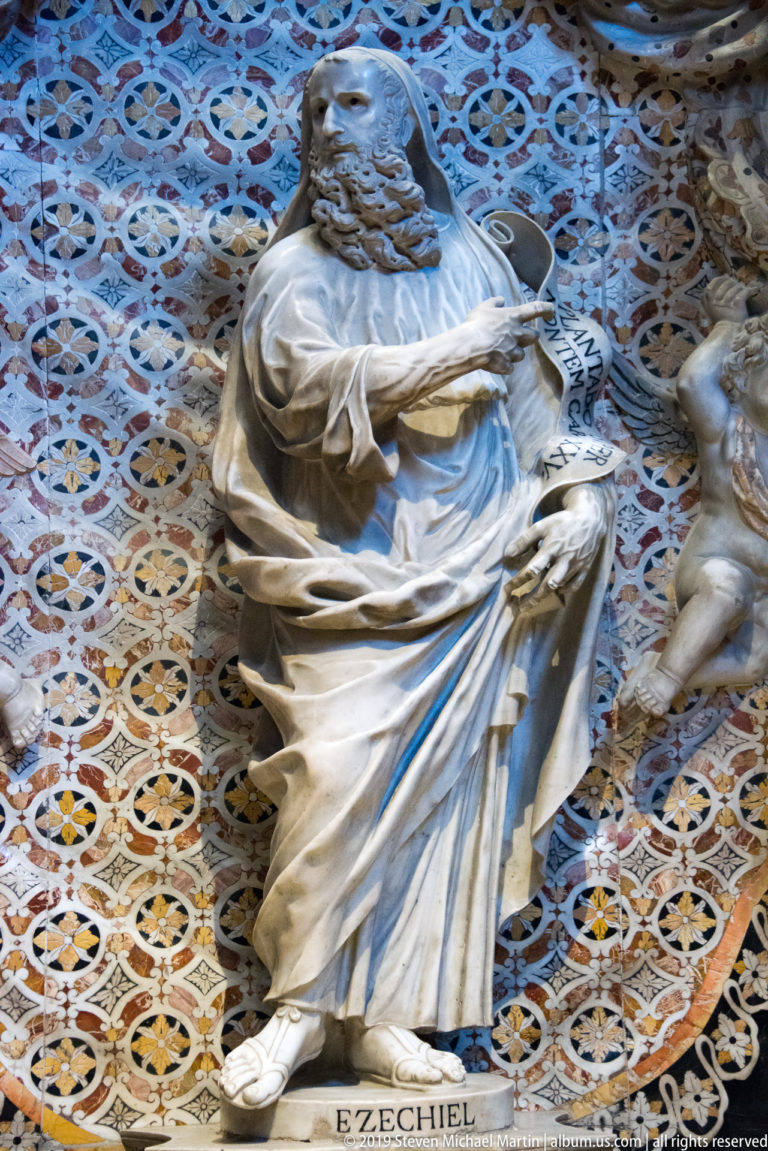 A bearded marble prophet labeled “EZECHIEL” holds a scroll in a patterned niche.