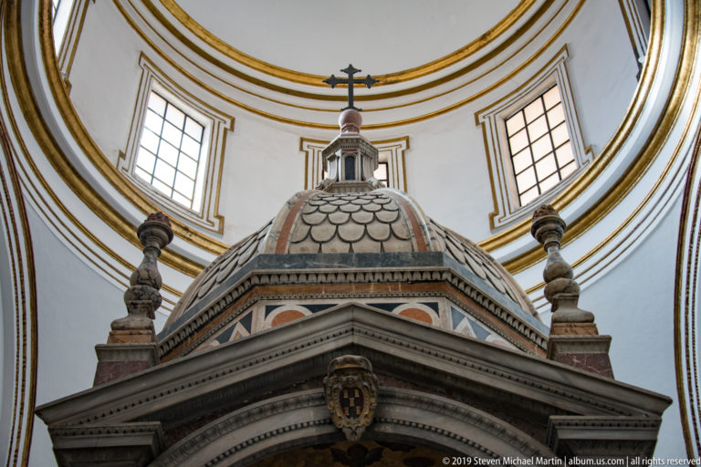 A marble ciborium with patterned columns and carved canopy above the altar in San Castrense’s chapel.