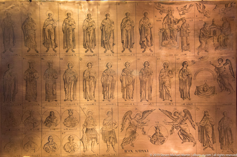 An ochre diagram lays out rows of saints and narrative scenes in a grid of labeled panels.