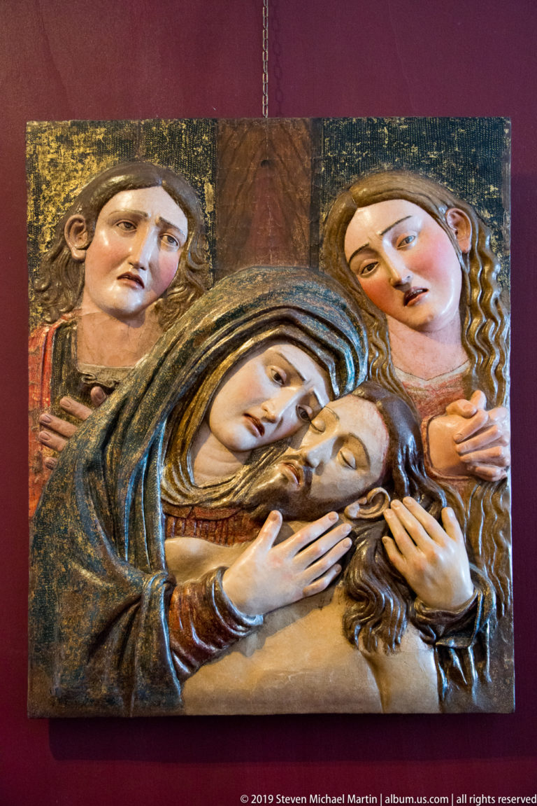 A frontal Madonna and Child appear in gold and blue mosaic, with the child raising a hand in blessing.