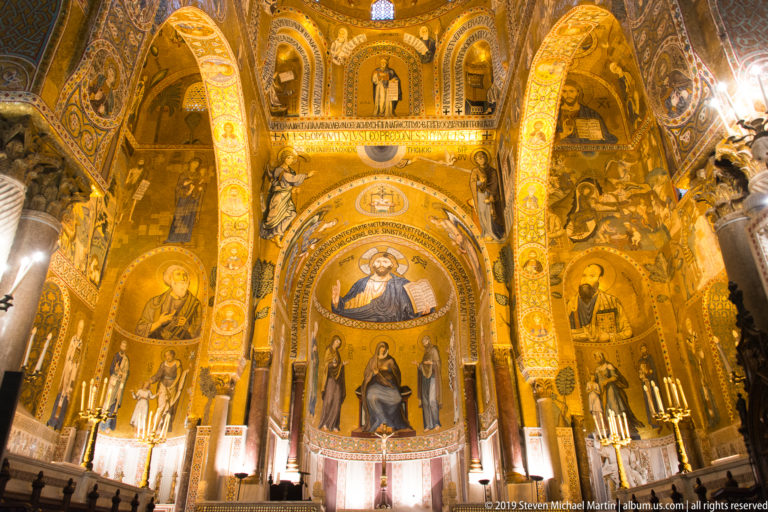 Upward view through mosaic-covered arches toward Christ Pantocrator and the Virgin and Child in the Palatine Chapel sanctuary.