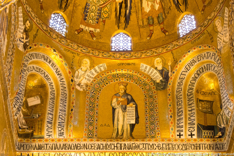 Standing saints in gold-ground mosaics beneath the chapel dome.