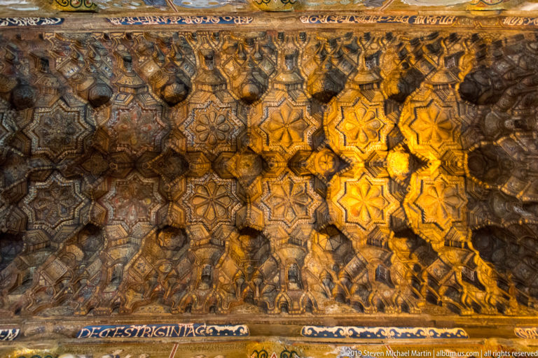 Carved and painted wooden muqarnas ceiling of the Palatine Chapel.