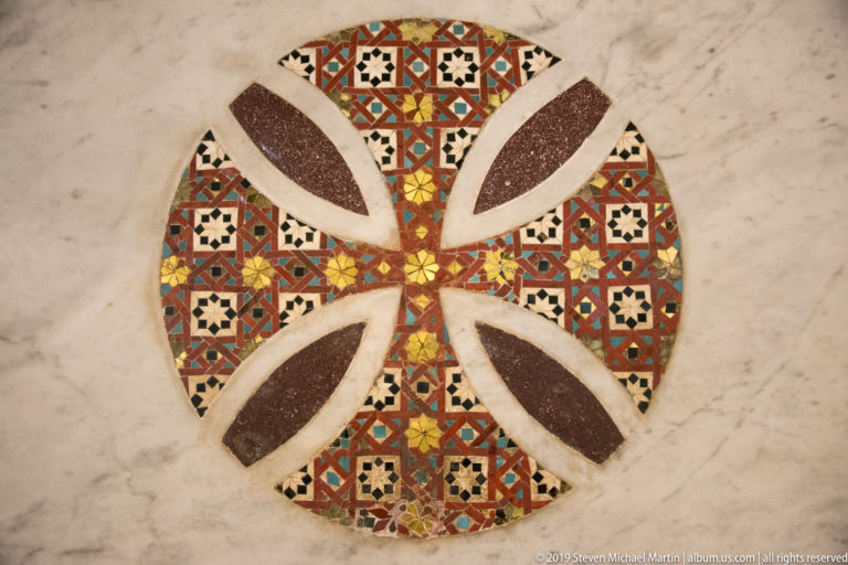 Four-lobed polychrome stone-and-mosaic pavement medallion.