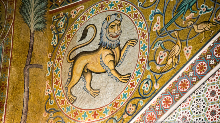 Stylized lion within an ornamental mosaic roundel.