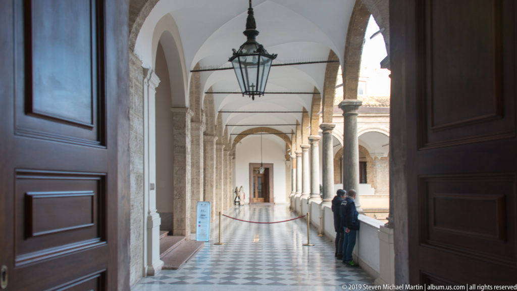 Long vaulted palace loggia overlooking the courtyard.