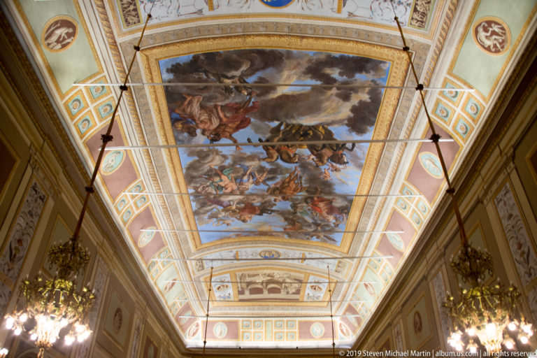 Large mythological ceiling painting with figures, horses, and clouds.