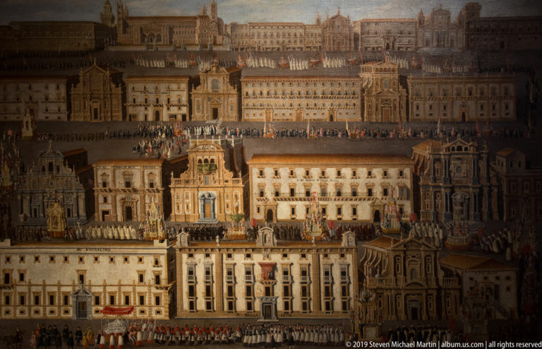 Historic painting of a dense monumental cityscape with palaces, towers, courtyards, and lines of small figures.