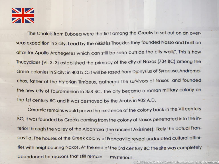 Close view of an English interpretive panel discussing Greek colonization, Naxos, Tauromenion, and early settlement in eastern Sicily.