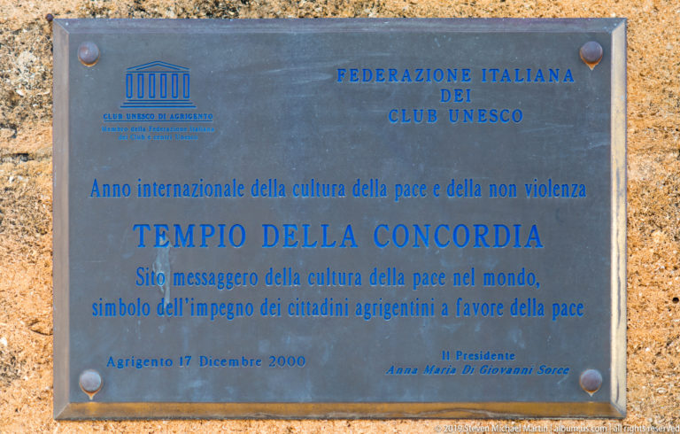 Blue-lettered metal plaque on stone naming the Temple of Concordia and commemorating a culture of peace in 2000.