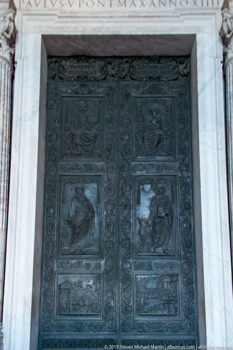 Filarete’s bronze Central Door with large figural relief panels set within the marble portico of Saint Peter’s Basilica.