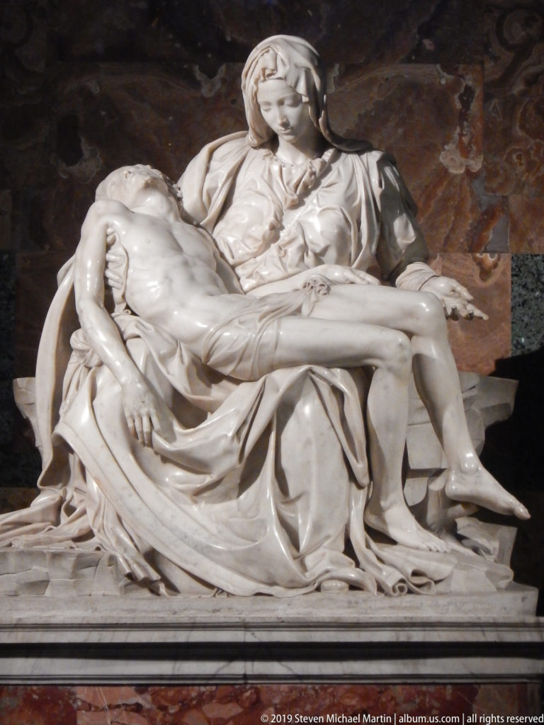Close view of Michelangelo’s Pietà, showing Christ lying across Mary’s lap with cascading marble drapery around both figures.