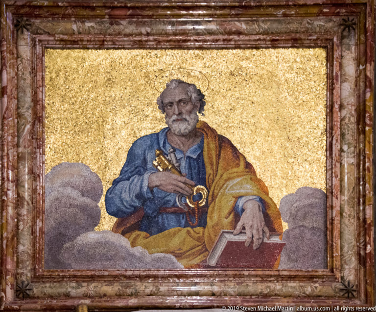Framed mosaic of Saint Peter seated on clouds, holding keys against a gold background with a book at his side.